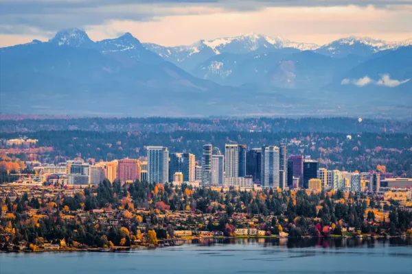 Cityscape reflecting mountains and autumn foliage, showcasing urban nature harmony and stunning landscapes.