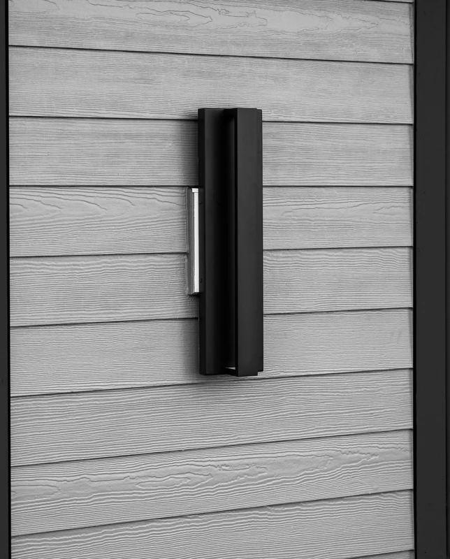 Sleek modern door handle on a textured gray door, combining style and functionality.