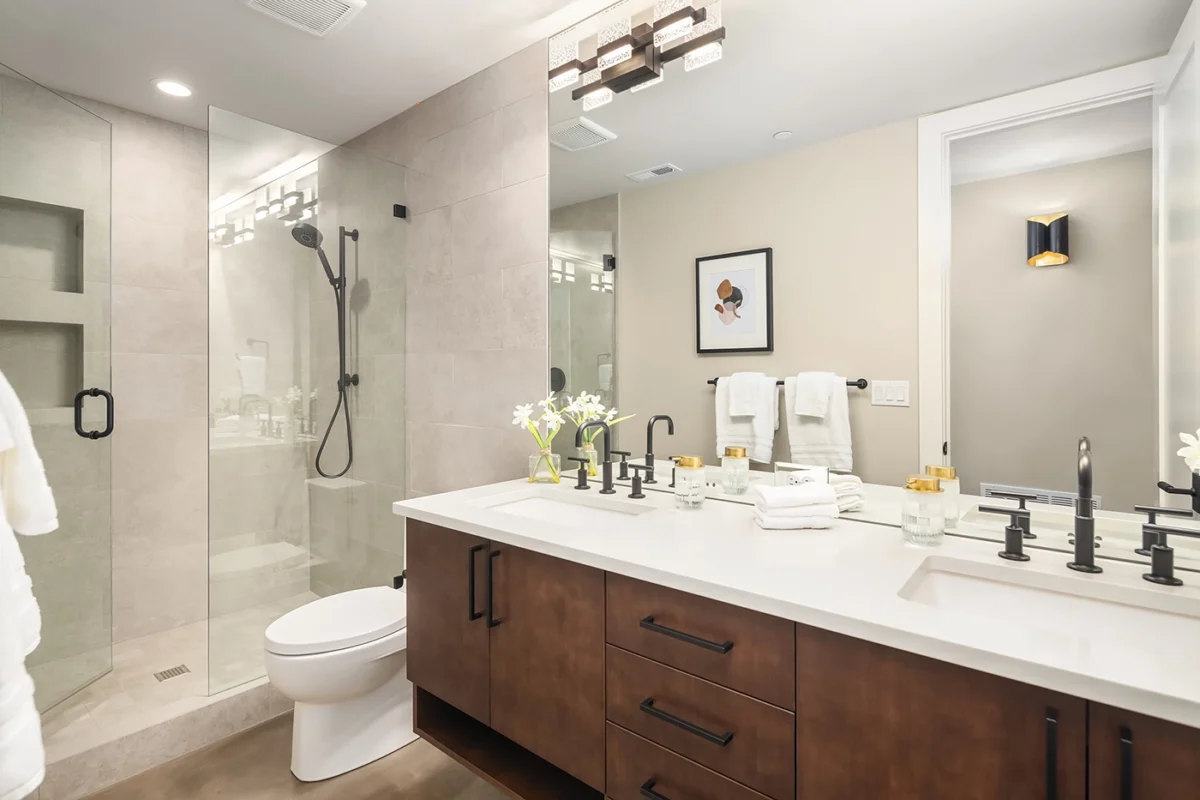 Modern elegant bathroom with sleek design, double sink vanity, and stylish shower features.