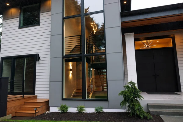 Contemporary home exterior with large windows, sleek materials, and inviting entrance design.