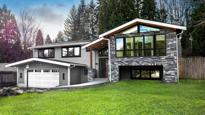 Modern two-story house in a lush landscape with contemporary design and natural privacy.