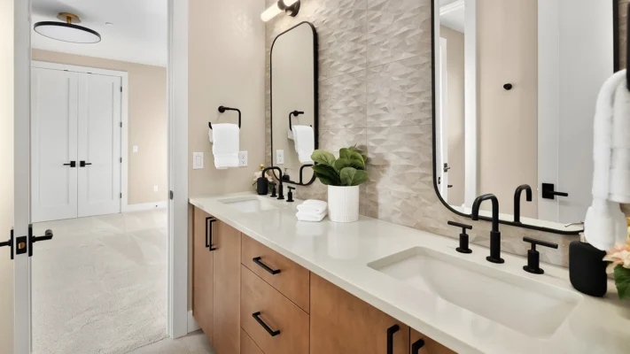 Elegant modern bathroom design featuring dual sinks, stylish cabinetry, and inviting natural light.