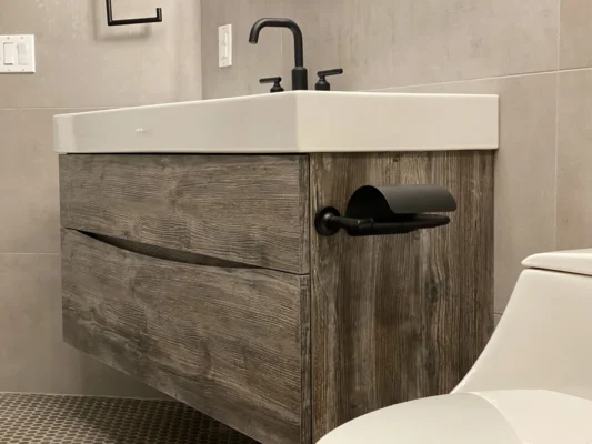 Sleek modern bathroom vanity with floating design, black fixtures, and warm wood accents.