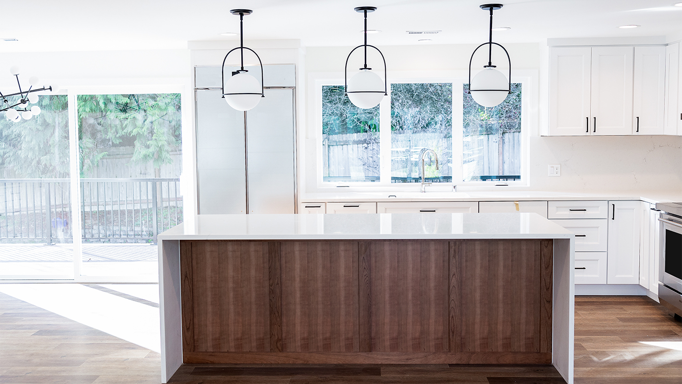 Stunningly remodeled kitchen featuring modern appliances, custom cabinets, and an open concept layout, showcasing the results of professional craftsmanship.