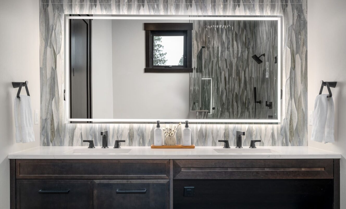 Stylish modern bathroom with double sink vanity, glass shower, and elegant design elements.