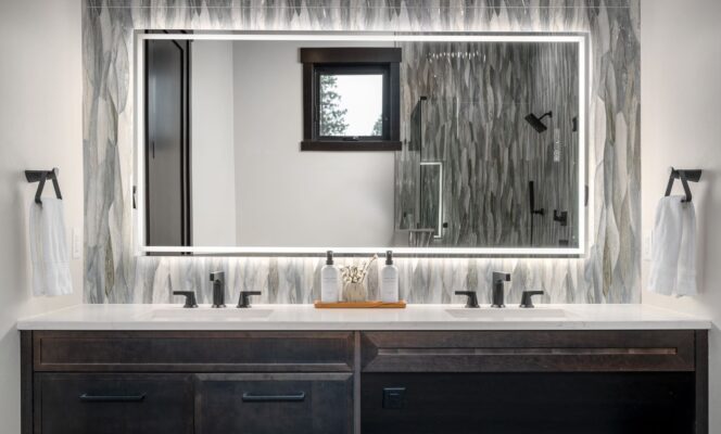 Stylish modern bathroom with double sink vanity, glass shower, and elegant design elements.