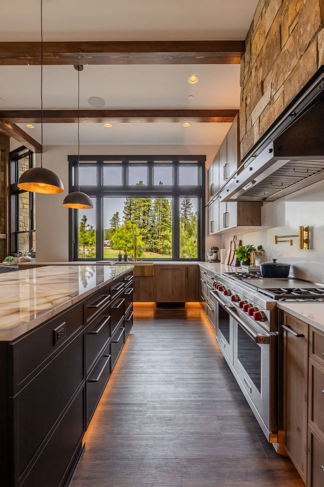 A sleek, gourmet kitchen in the Suncadia Grand Retreat with advanced appliances, expansive countertops, and contemporary design.