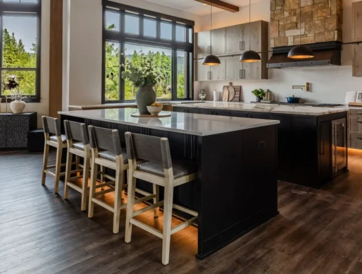 Contemporary kitchen with black island, white quartz countertops, and forest views remodeled by ARIID Build & Remodel kitchen remodeling contractors