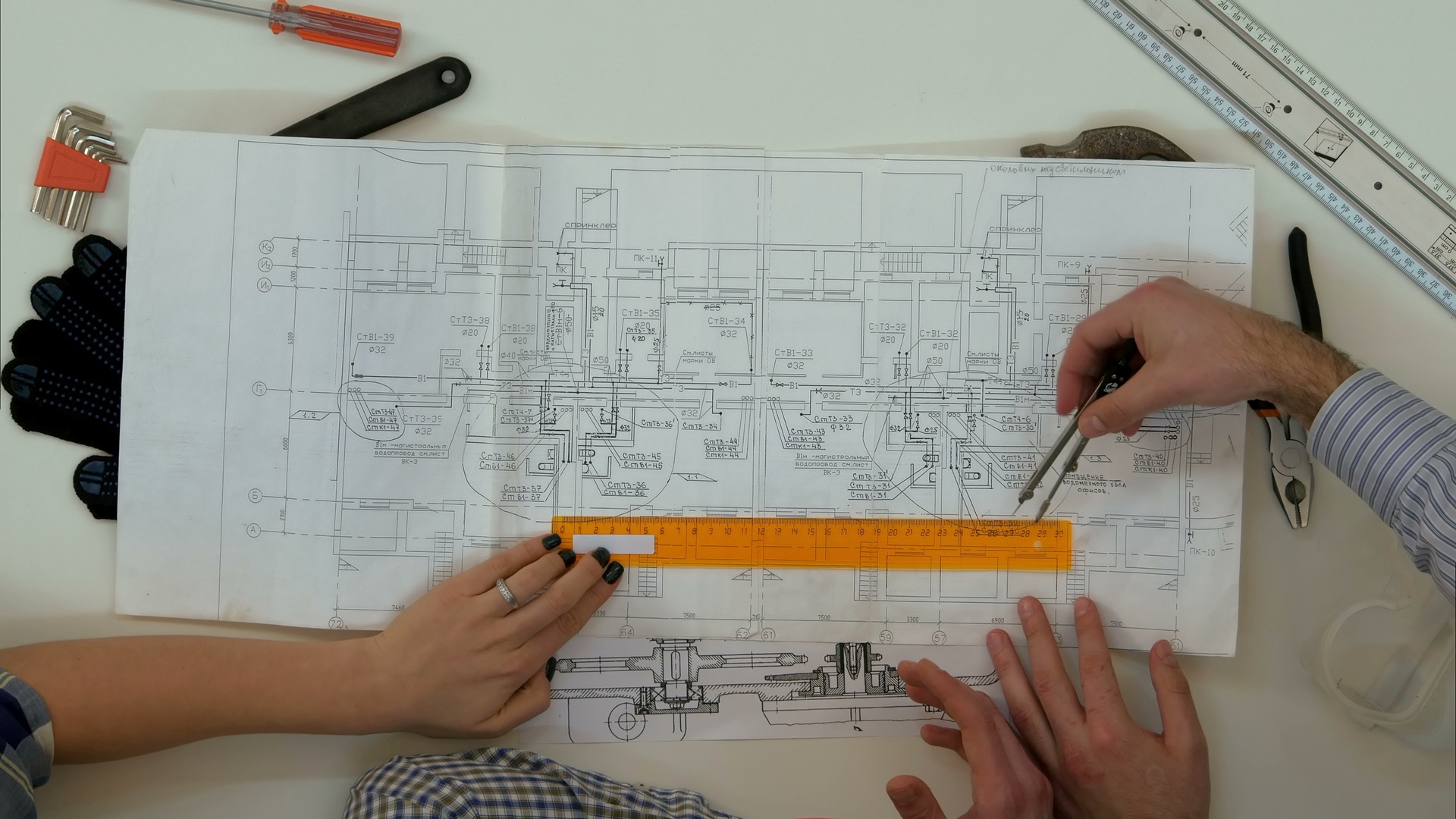 General contractor from ARIID Build & Remodel reviewing architectural plans with homeowners in a Kirkland living room, discussing custom renovation options.